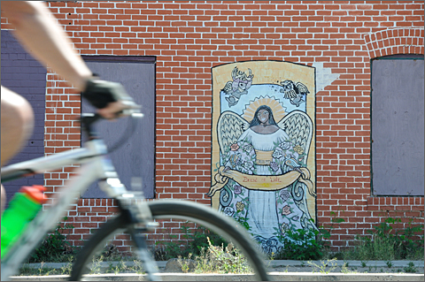 Bicycle photography - Cyclovia Tucson rider passing mural on 4th Avenue