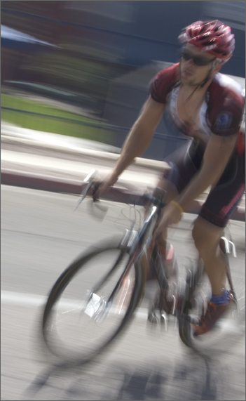 Bicycle photography - Racer rounding a corner during criterium, Tucson, Arizona