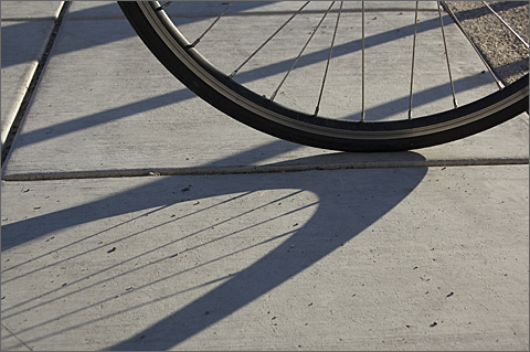 Bicycle photography - wheel and shadow at twilight, Tucson, Arizona