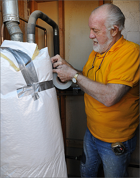 Event and construction photography: Insulating the hot water heater in a Tucson, Arizona residence