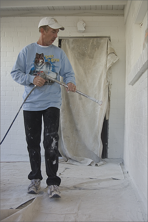 Construction photography - using a sprayer to paint a Tucson, Arizona house