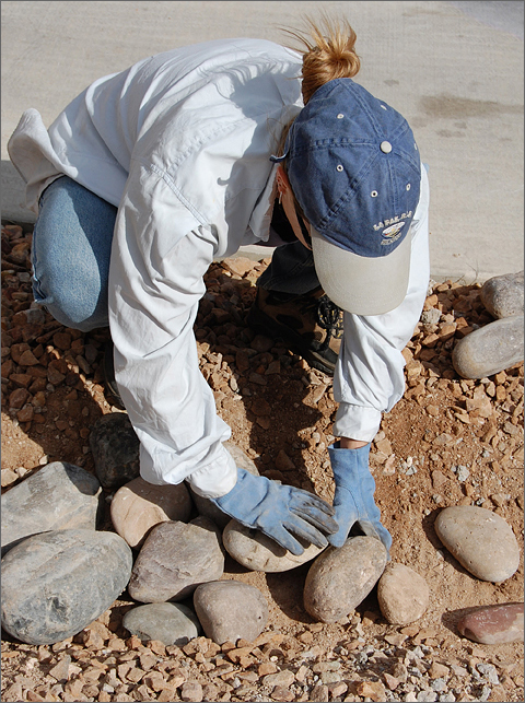 Construction photography - Lining a drainage swale with river rock