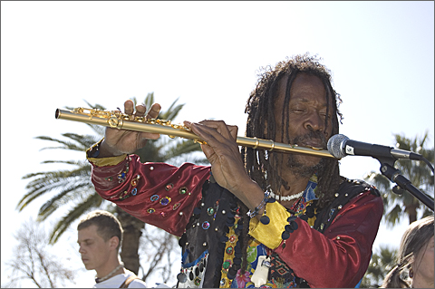 Event photography - Spirit Familia band leader Jomo plays flute at Tucson Carnaval 2010