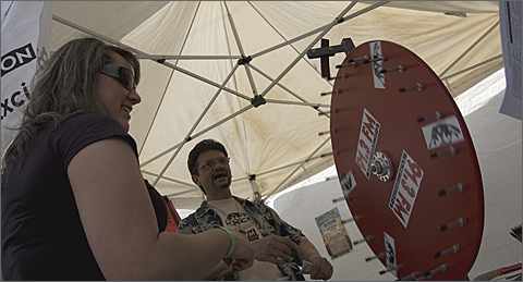Event Photography - Spinning the KXCI prize wheel at the 4th Avenue 2010 Spring Street Fair, Tucson, Arizona