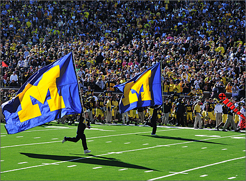 Event photography - Flag runners at the start of the Michigan Marching Band performance before the 2010 Homecoming Game