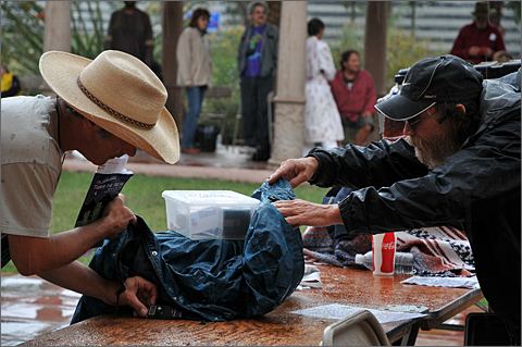 Event photography - Sudden downpour forces sound technicians to cover equipment at the 2010 Tucson Folk Festival