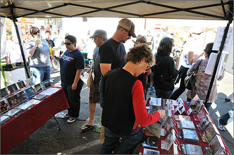 Event photography - Local music lovers browse through the selection at the KXCI Community Radio booth, 4th Avenue 2010 Winter Street Fair, Tucson, Arizona