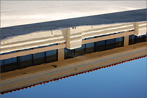 Nature photography - Building reflected in parking lot along the Rillito Creek, Tucson, Arizona
