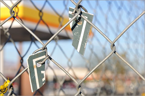Photo essays - Fence surrounding vacant gas station, Tucson, Arizona