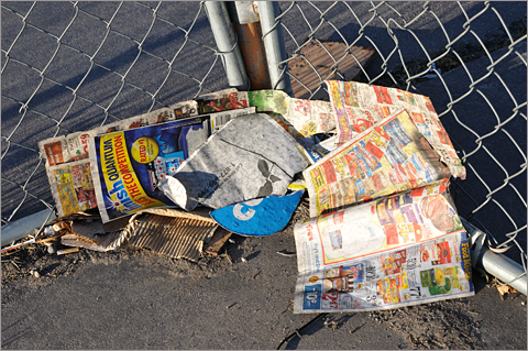 Photo essays - Trash at fence surrounding vacant gas station, Tucson, Arizona